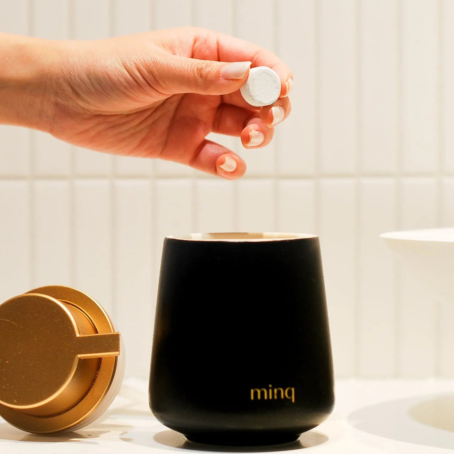 Drop cleaning tablet into dispenser bottle
