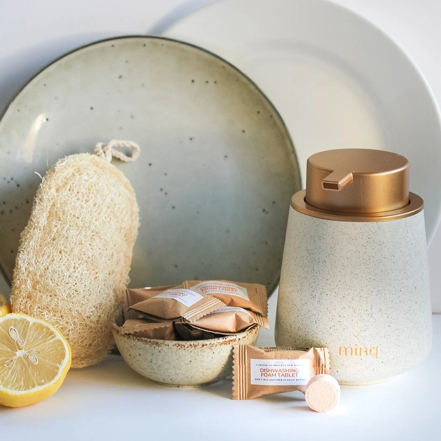 Kitchen Dishwashing Detergent with Foam Dispenser and Loofah Sponge placed in front of 2 dishes